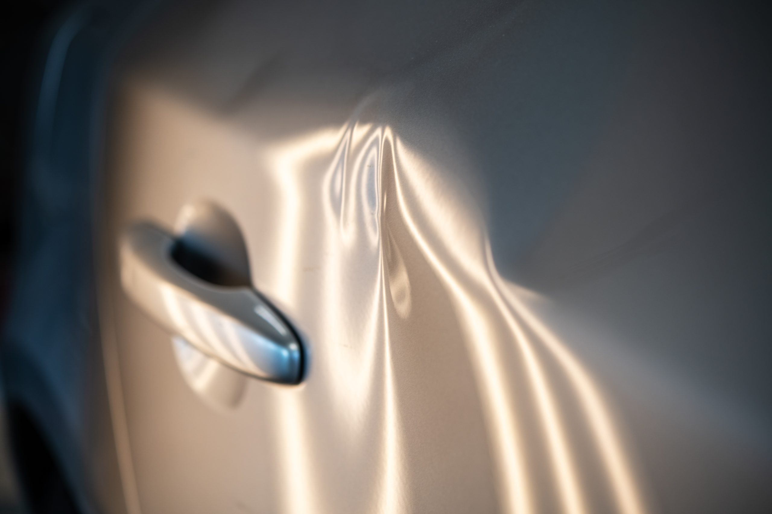 A car needing dent repairs in a panel shop
